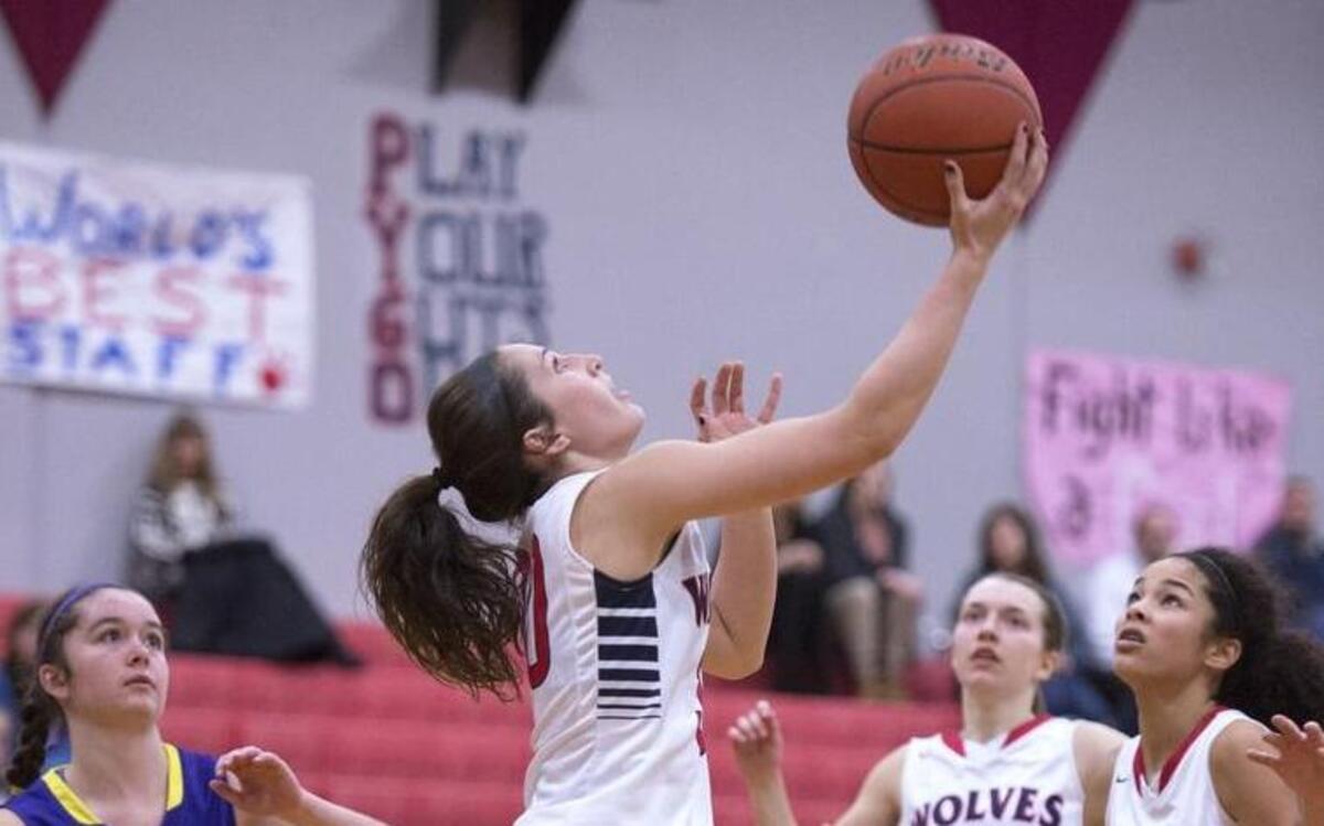 Black Hills sophomore guard Lindsey Nurmi drives the baseline for a reverse layup in front of Columbia River defender Anna Klundt and teammates Sammi Payne (21) and Maisy Williams on Tuesday.