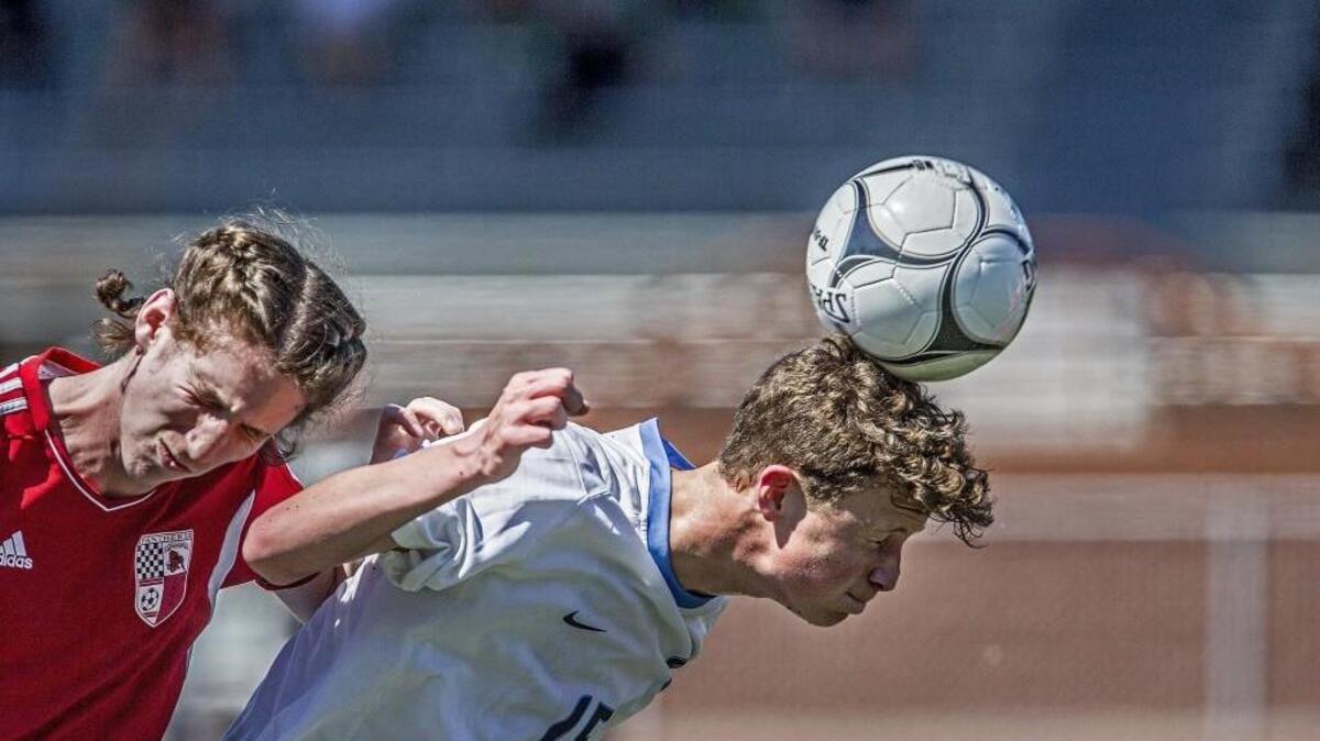 Gig Harbor's Trevin Snell battles Snohomish midfielder Bohdi Uderitz for the ball in the first half of a 3A soccer state semifinals at Sparks Stadium in Puyallup. Snohomish won, 4-3.