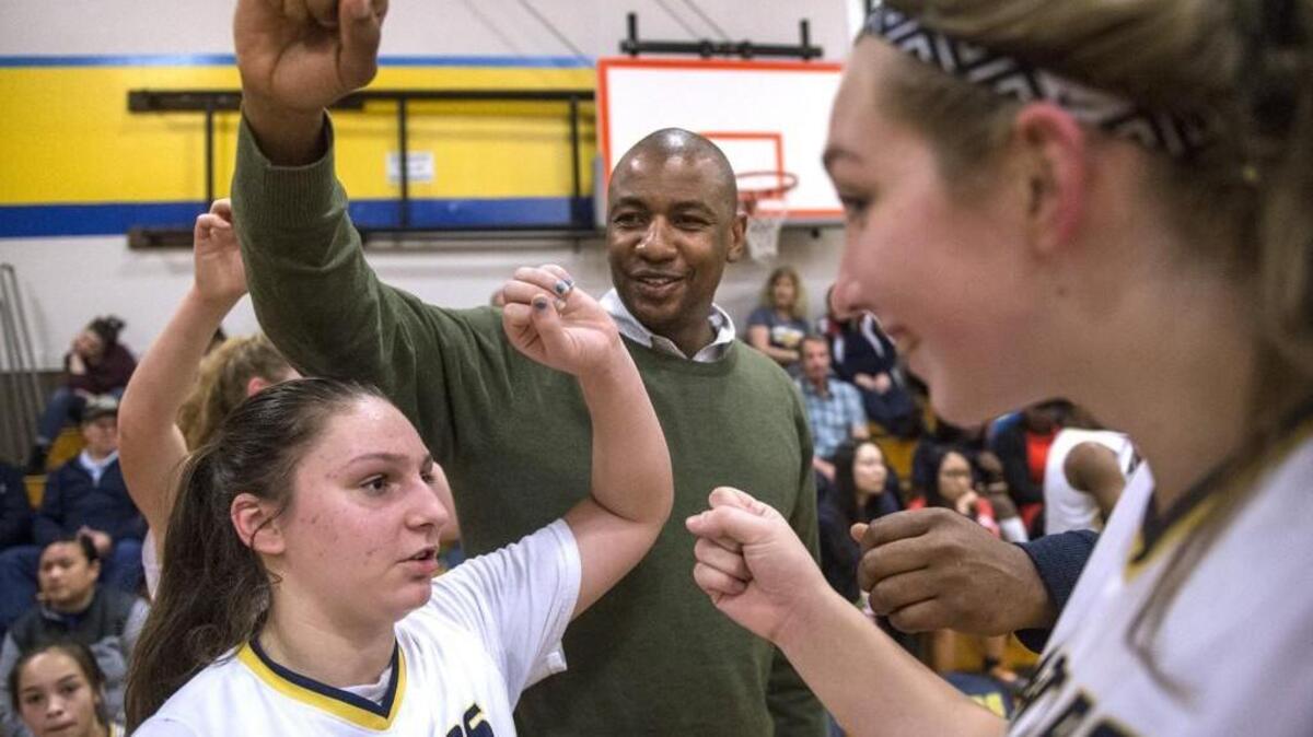 Annie Wright freshman Julianna Walker (from left), head coach Chris Spivey and senior Raquel Berman fire up the Gators during a time out in Wednesday night's girls basketball game against Bush at Annie Wright Schools in Tacoma on Feb. 7, 2018.
