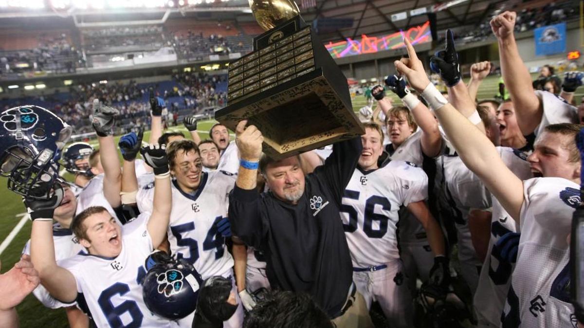 Cascade Christian head coach Randy Davis, center, holds the trophy up after winning 42-34 over Connell in the state 1A high school football championship game, Saturday, Dec. 4, 2010, in Tacoma, Wash.
