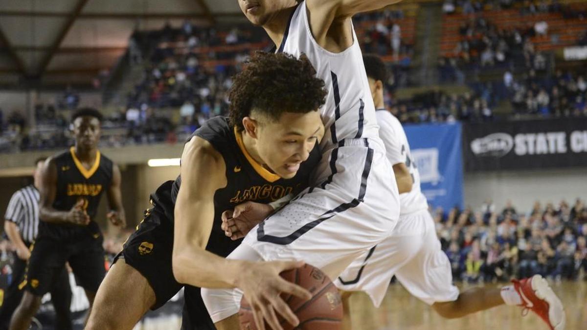 Lincoln's Trevante Anderson (0) drives to the hoop while defended by Nathan Hale's Tre'Var Holland (13) in the fourth quarter. Lincoln played Nathan Hale in a basketball game at the Tacoma Dome in Tacoma, Wash., on Friday, March 3, 2017.