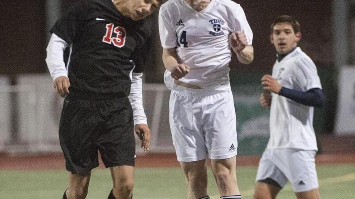 Tacoma Baptist's Riley Byrne, right, heads the ball away from Jackson Kimmel of Crosspoint. Photo taken in Sumner on Friday, Nov. 20, 2015.