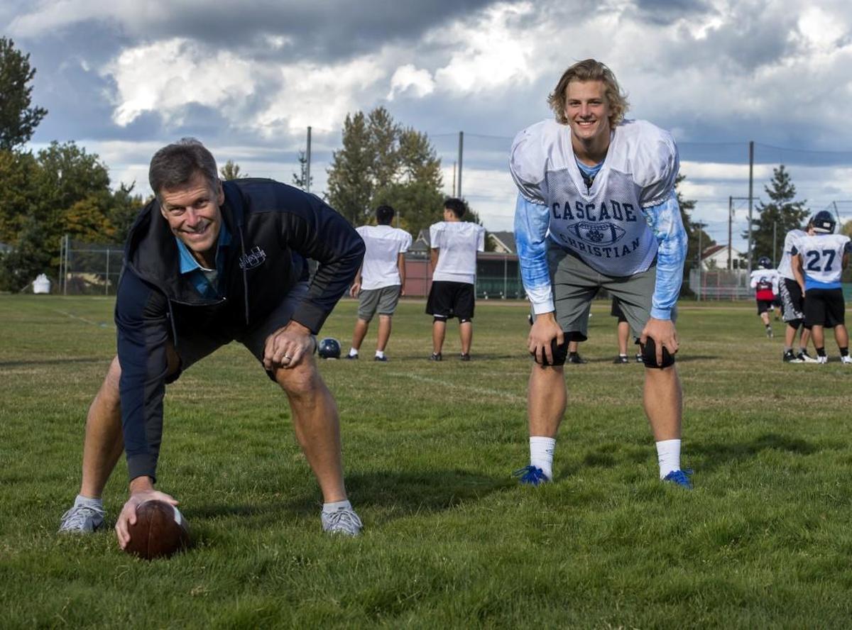 Although Robbie Tobeck was a center for the Seattle Seahawks, his son, Madden, right, has chosen a different football path as a running back for Cascade Christian. Photo taken in Puyallup on Wednesday, Oct. 11, 2017.