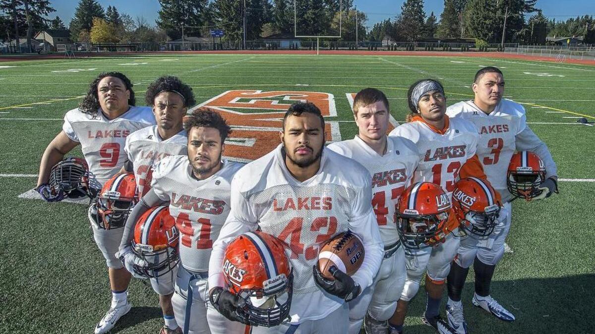Lakes coach Dave Miller points with pride to his front seven (from left): Jo-bently Keilani, Xavier Banner, Elijah McMillon, Max Nauer, Cale Lindsay, Maika Magalei, Kenny Fua. In the second half of a district playoff victory over O’Dea, the stingy Lancers allowed minus-eight yards.