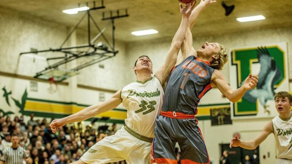 Peninsula’s Austin Kingman (33), left, battles Auburn Mountainview’s Talan Alfrey (1) at Peninsula High School.