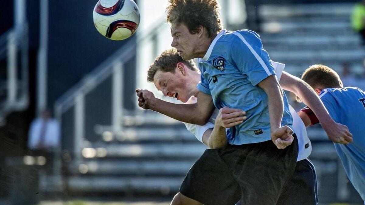Bellarmine Prep’s Bryce Gardner (white jersey) is sandwiched by Gig Harbor players as he goes for the ball. Gardner scored the first goal in the 44th minute on Thursday.