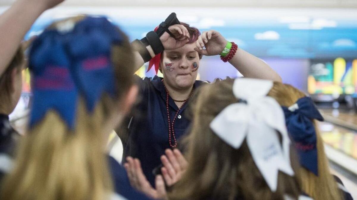 Wilson’s Mekade Taylor celebrates a strike with teammates during the State Girls Bowling Championships at Narrows Plaza Bowl in Tacoma on Friday, Feb. 2, 2018.