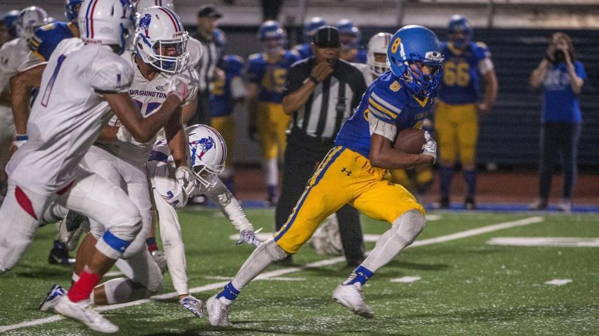 Lavelle Alexnder of the Fife Trojans rambles for about 25 yards in the fourth quarter against Washington High Patriots in a football game in Fife, September 8, 2017.