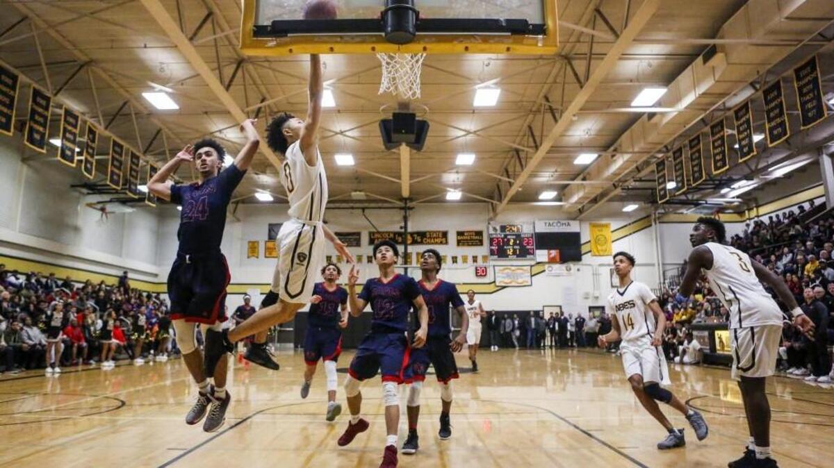 Lincoln's Trevante Anderson (0) drives to the hoop to score in the second quarter. Lincoln played Wilson in a basketball game at Lincoln High School in Tacoma, Wash., on Wednesday, January 25, 2017.