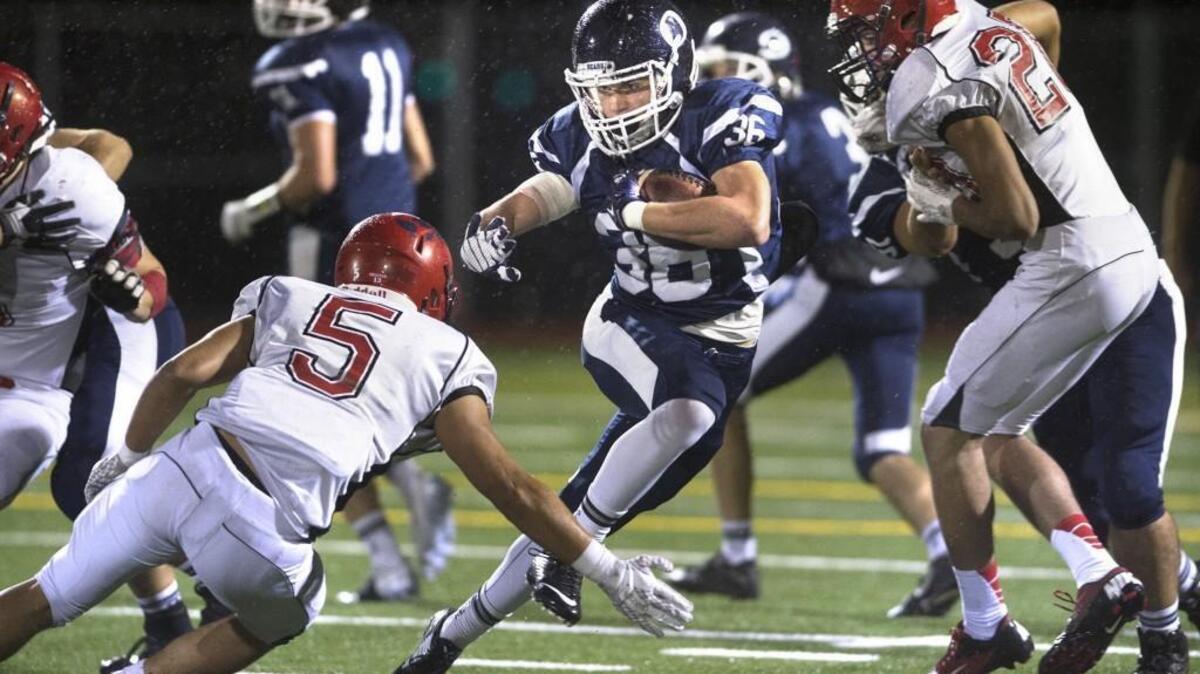 Olympia running back Scott Gunther fights off Yelm linebacker Jason Frye (5) during Friday night's 4A Narrows League football game at Ingersoll Stadium in Olympia on Oct. 30, 2015.