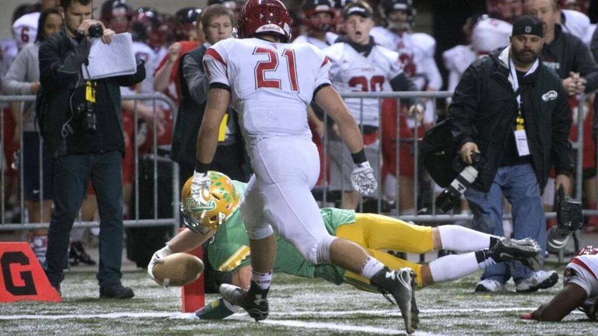 Tumwater’s Noah Andrews dives into the end zone ahead of Archbishop Murphy defender Austin Earl for the go-ahead touchdown late in the 2A semifinal at the Tacoma Dome in November 2015. Tumwater won, 24-21, ending the Wildcats’ up-until-then perfect season.