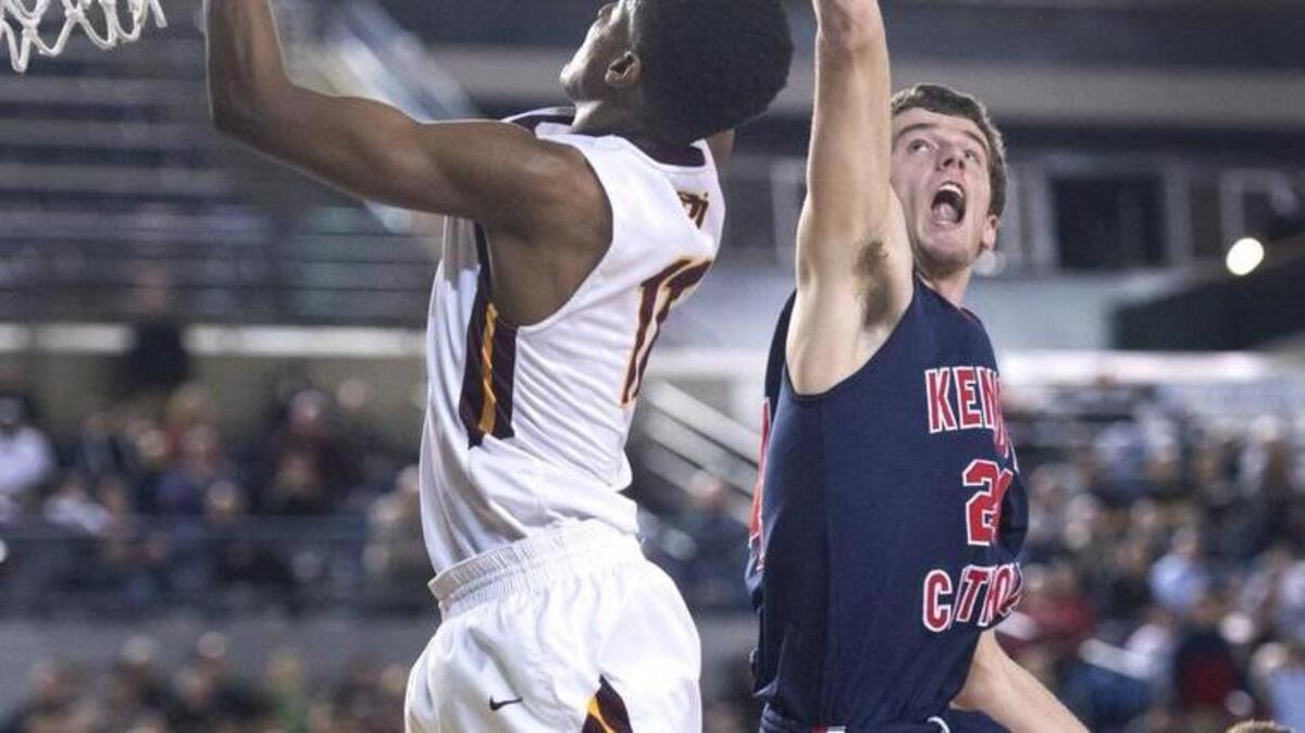 O'Dea's Xavier Smith,left, battles Kennedy Catholic's Jarad Thurber for a rebound in the first half. Photo taken in Tacoma on Friday, Mar. 4, 2016.