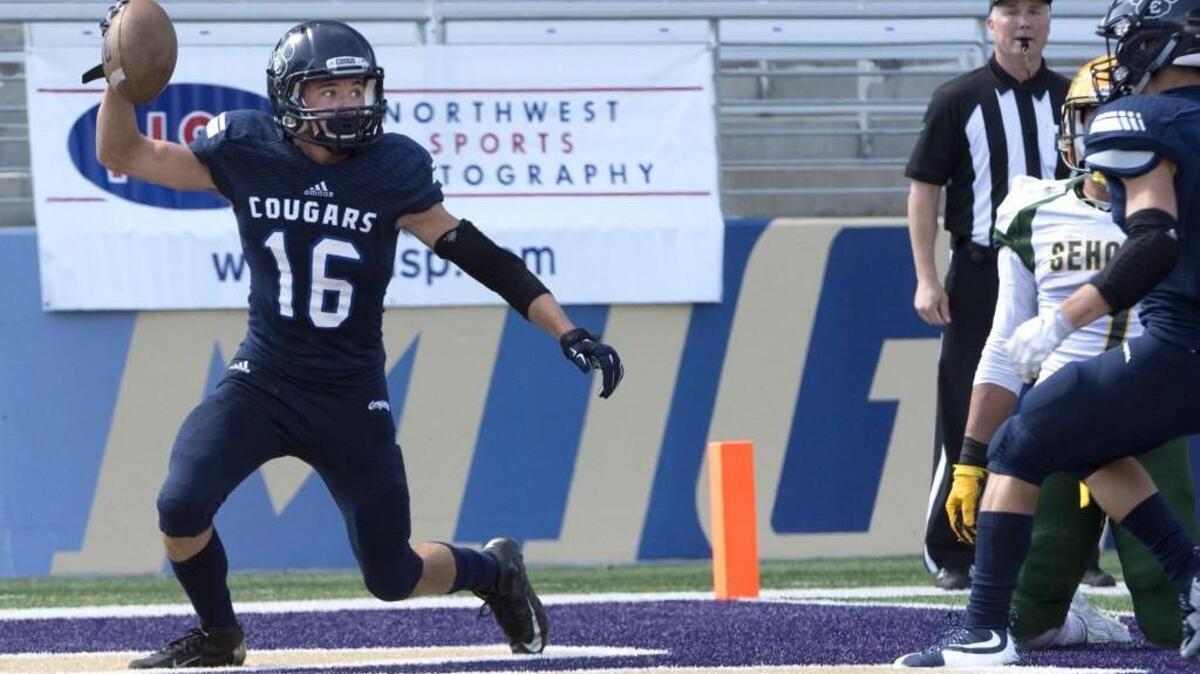 Cascade Christian's Austin Carder, 16, celebrates in the end zone after scoring a touchdown against Sehome on Saturday.