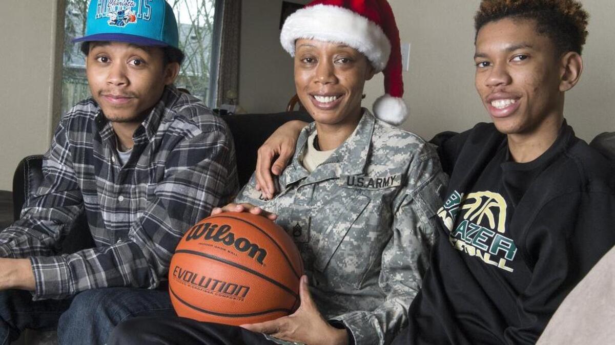 Austin Curry, right, and his brother Alex are happy to have their mom, Aretha, home for Christmas this year. She has served Army deployments to Iraq and Afghanistan. .