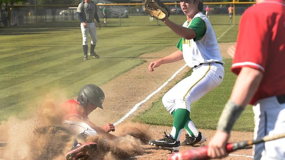 Black Hills baserunner Ethan Loveless scores on a passed ball as Tumwater pitcher Joseph Brascher looks for the throw from his catcher in the first inning. The win places the Wolves as the No. 3 seed out of the 2A Evergreen Conference for the District 4 tournament.