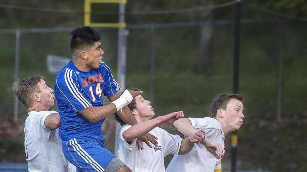 Auburn Mountainview's Erik DeAnda, second from left, timed his leap for a header goal rising above Raven defenders. He earned MVP of the 4A NPSL Olympic division.