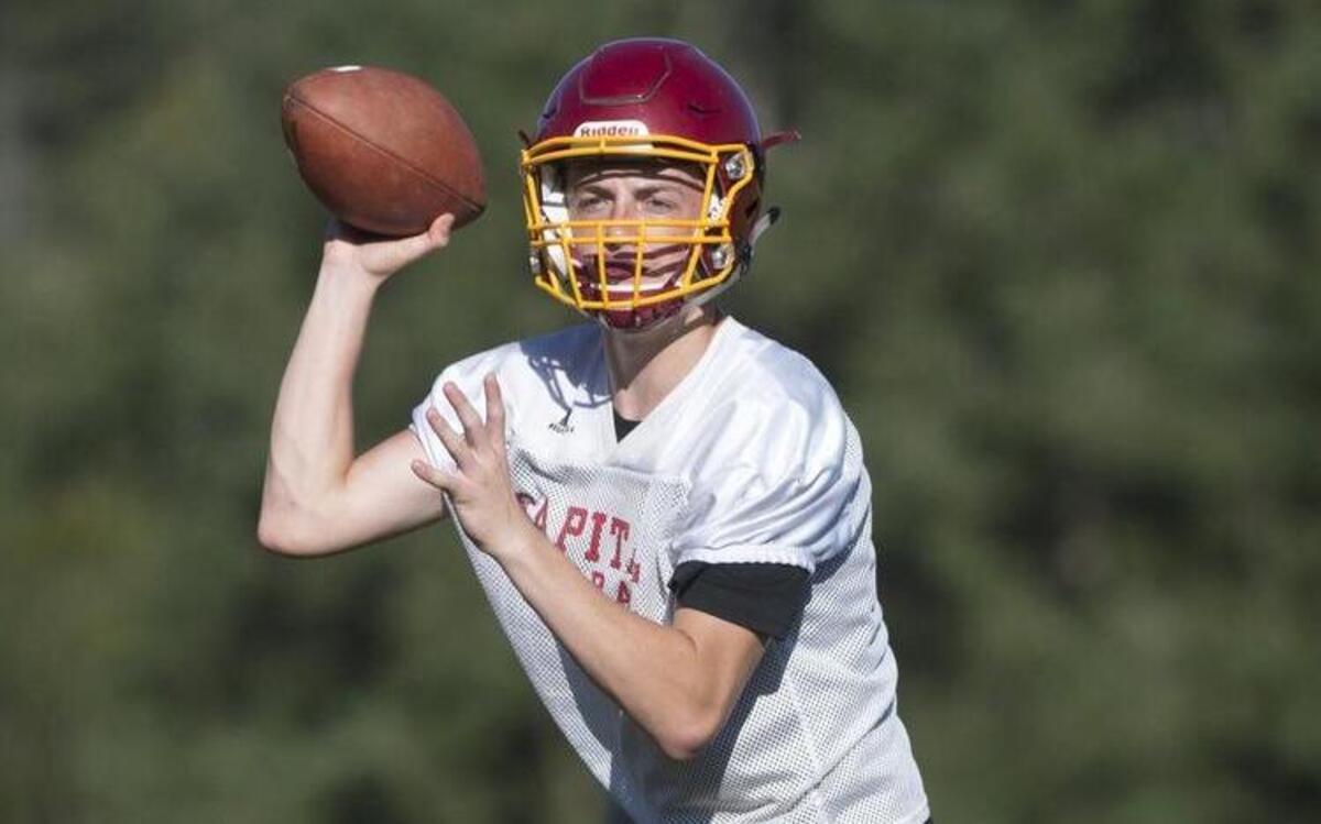 Capital sophomore quarterback Grant Erickson runs through drills during preseason football practice at Capital High School in Olympia on Friday, Aug. 19, 2016.