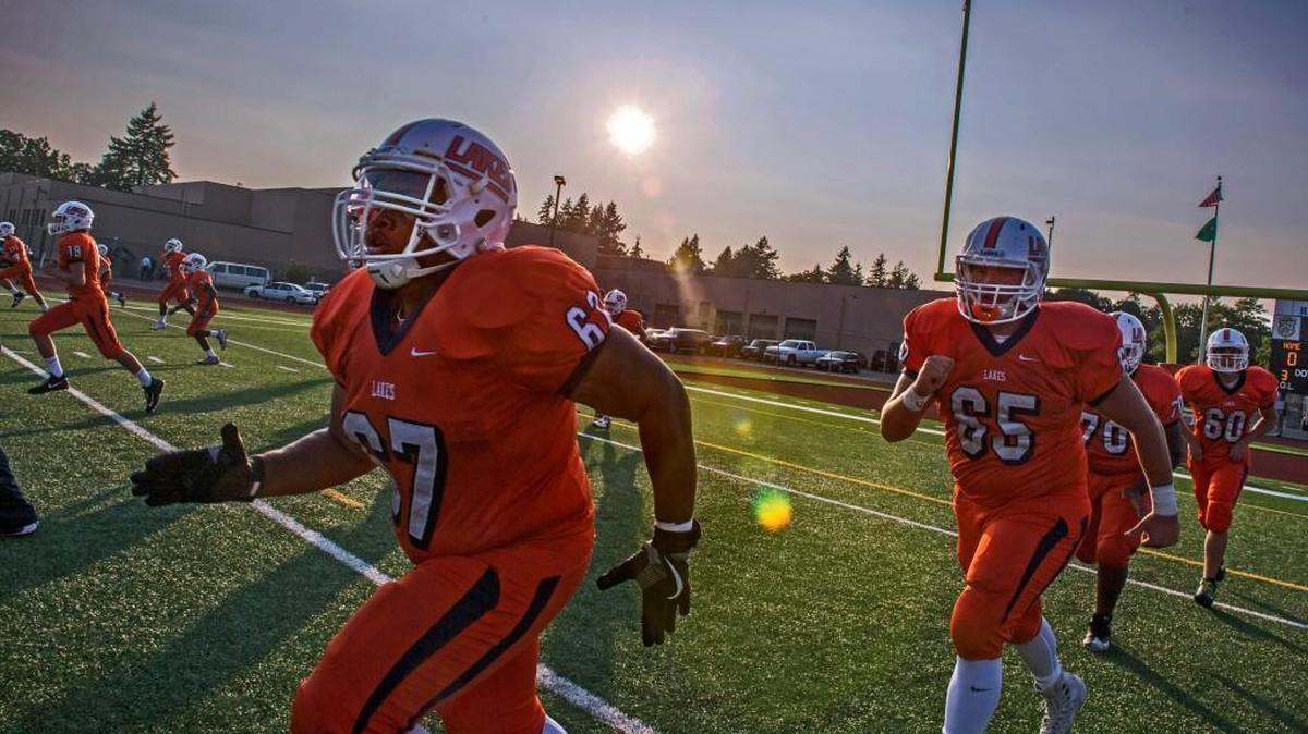 The Lakes High School Lancers football team warms up before the game against Bellarmine Prep at Harry Lang Stadium in Lakewood, September 8, 2017.