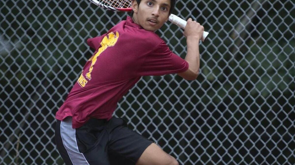 Capital’s Ranjan Sharangpani winds up for a backhand during a match against North Thurston’s Joonick Ahn.