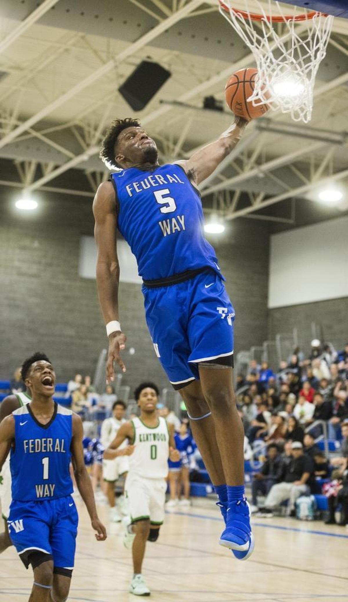 Federal Way's Etan Collins dunks in the second quarter. Federal Way played Kentwood in a basketball game to decide the 4A NPSL title at Tahoma High School in Maple Valley, Wash., on Saturday, Feb. 3, 2018.