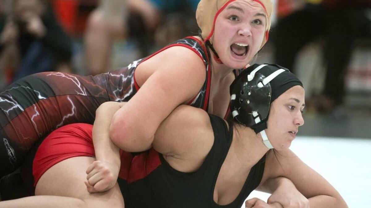 Yelm’s Ariana Zemke, top, looks to her coaches as she works to flip Shelton’s Matlyne Mecham in their 155-pound division consolation match. Zemke won 17-8.