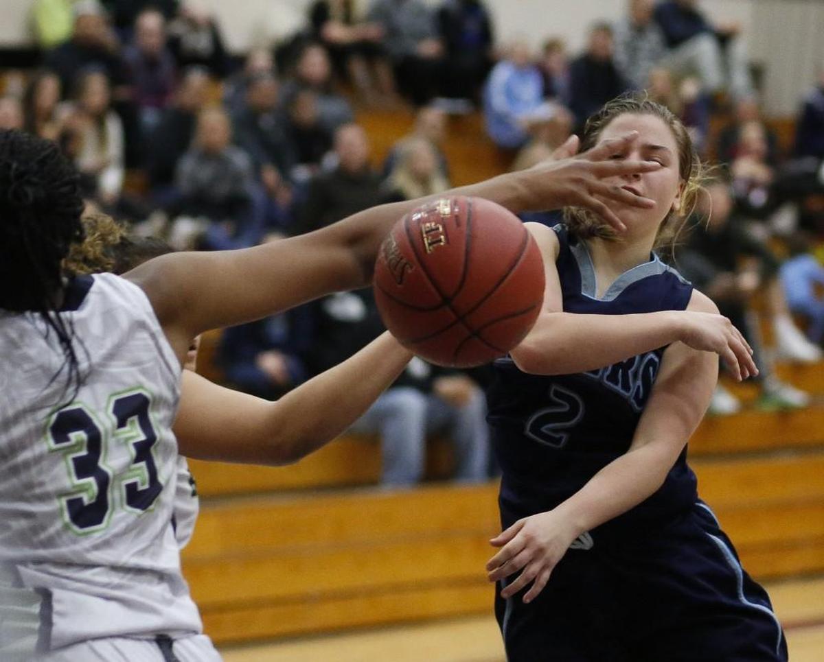 Rogers' Raigan Barrett (2) passes with a hand in her face in the fourth quarter. Rogers High School played Todd Beamer in a basketball game at Puyallup.
