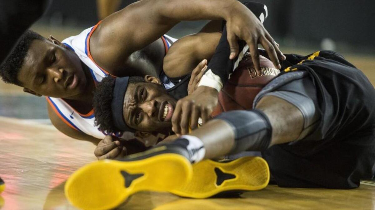 Lincoln's Willie Thomas III (5) and Rainier Beach's Kendall Williams (33) go after a loose ball in the third quarter. Lincoln played Rainier Beach in a semifinal bracket game at the Hardwood Classic state basketball tournament at the Tacoma Dome in Tacoma, Wash., on Friday, March 2, 2018.