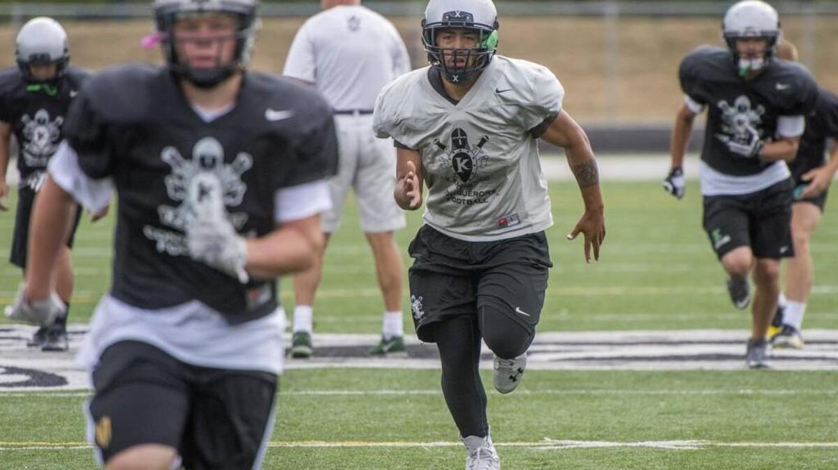 Kentwood running back Chavez Kalua-Fuimaono warms up during a practice on Tuesday.