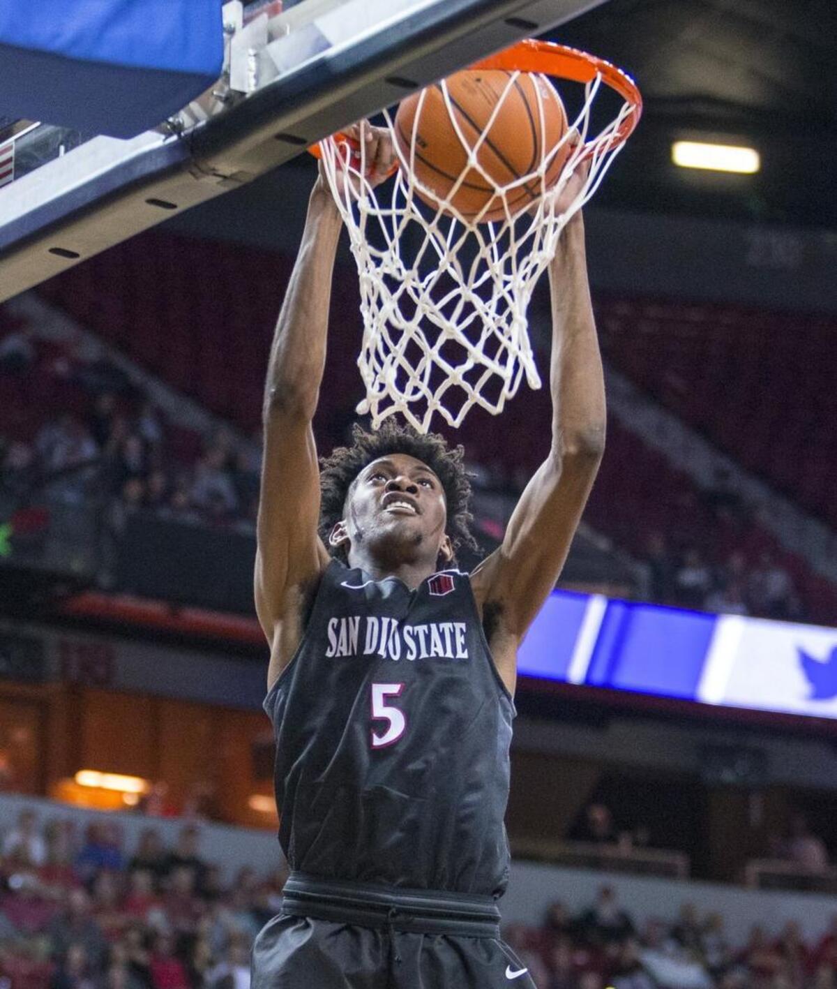San Diego State forward Jalen McDaniels (5) dunks the ball over Nevada during the second half of an NCAA college basketball game against Nevada in the semifinals of the Mountain West Conference tournament Friday, March 9, 2018, in Las Vegas.