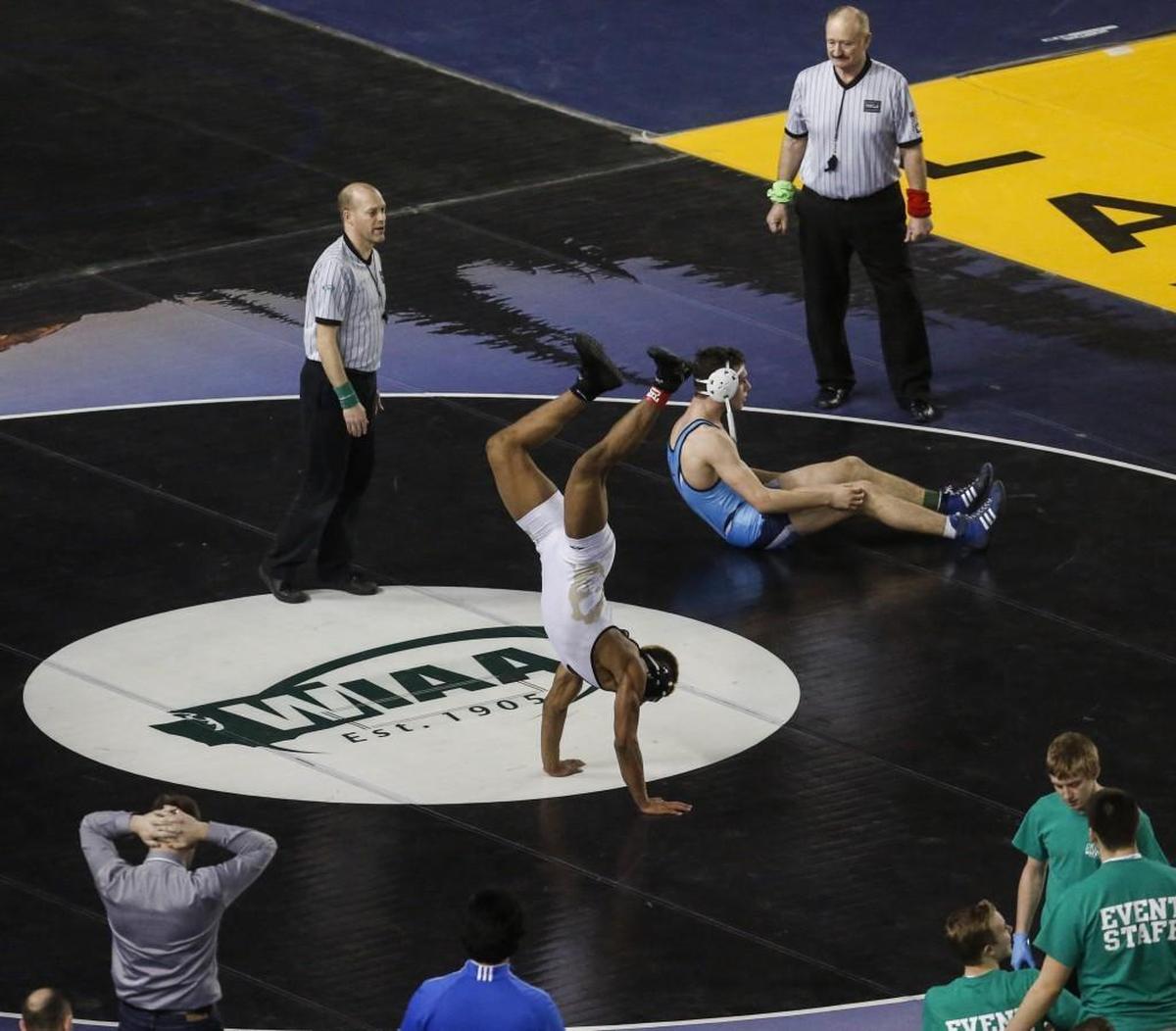 Lincoln's J.J. Dixon flips after defeating Meadowdale's Liam Ball in the 3A 182 pound championship match at Mat Classic XXIX at the Tacoma Dome in Tacoma, Wash., on Saturday, February 18, 2017.