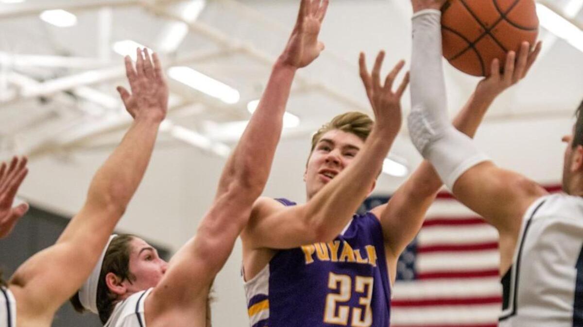 Tony Gutierrez of Puyallup High School faces stiff resistance from Joey Bodoia (left) and Christian Moore in the final game of the Bellarmine Christmas Classic basketball tournament, December 30, 2015.