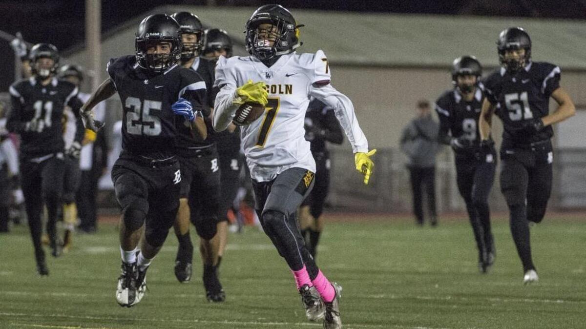 Lincoln's Kavon Holden (7) returns the opening kickoff for a touchdown in the first quarter. Bonney Lake played Lincoln in a football game at Sunset Stadium in Sumner, Wash., on Friday, Oct. 20, 2017.