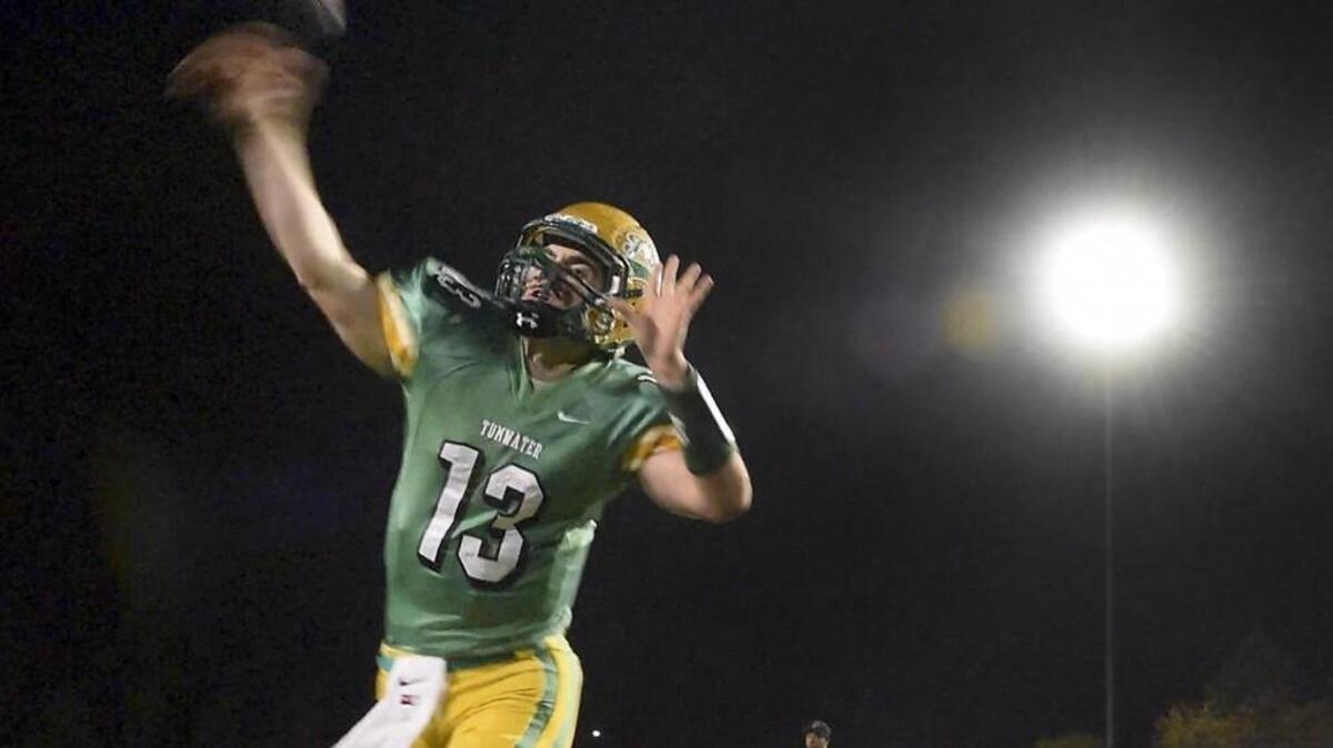 Tumwater quarterback Spencer Dowers warms up before the T-Birds' 2A football state playoff game against the Franklin Pierce Cardinals at Tumwater District Stadium on Friday, Nov. 13, 2015.