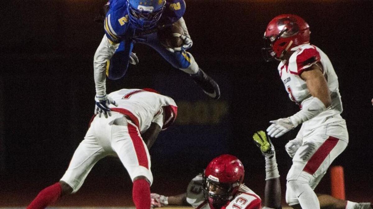 Fife's Day'Jon Brooks (2) hurdles Steilacoom's Andrew Propes (7) in the third quarter. Fife played Steilacoom in a football game at Fife High School in Fife, Wash., on Friday, Oct. 27, 2017.