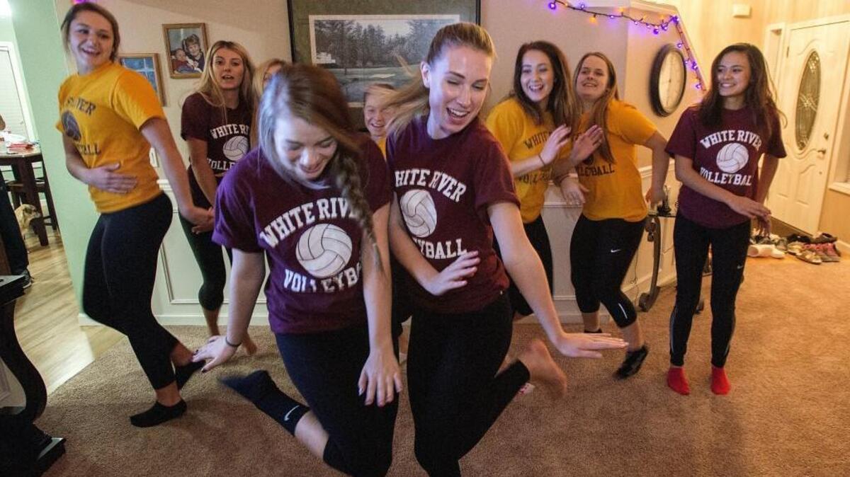 White River’s Emily Kunst, Shaylee Thompson, foreground right, and fellow volleyball team members practice their moves for a dance-off against the football team.