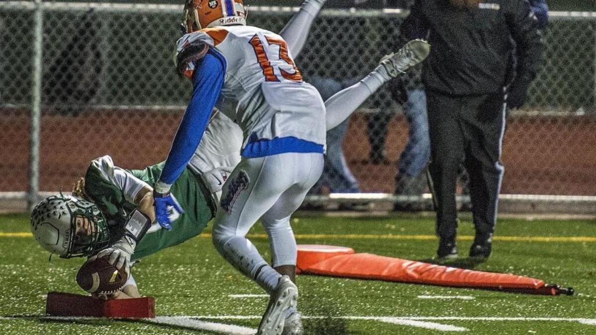Seahawks quarterback dives for a touchdown during the 3A state quarterfinal football game between Peninsula High School Seahawks and Rainier Beach High School Vikings at Roy Anderson Field in Purdy, Wash., Friday, Nov. 17, 2017.