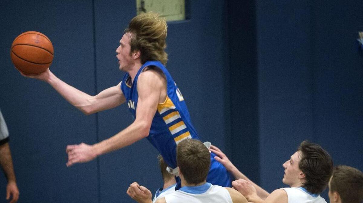 Stadium’s Bobby Moorehead flies by Olympia defenders at Olympia High School on Friday, Dec. 19, 2014.