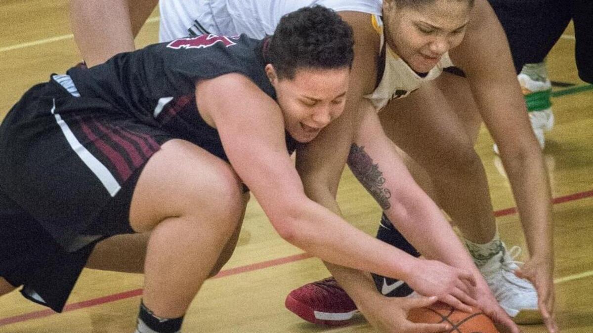 Kentlake's Jada Leonard, left, locks up with Kentridge's JaQuaya Miller while going for the loose basketball at Kentridge High School in Kent on Friday, Jan. 20, 2017.