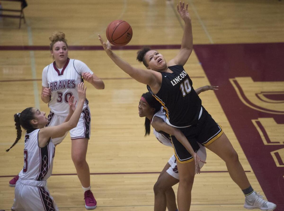 Lincoln’s Sharayah Johnson (10) grabs a rebound in the second quarter. Lincoln played Bethel in a basketball game at Bethel High School in Spanaway, Wash., on Friday, Jan. 5, 2018.