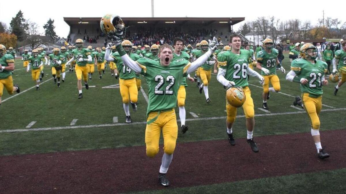 Tumwater senior Jakob Holbrook leads teammates as they celebrate the T-Birds' 10-6 state semifinal victory over Archbishop Murphy in Satuday's 2A state football semifinal at Sparks Stadium in Puyallup on Nov. 25, 2017.