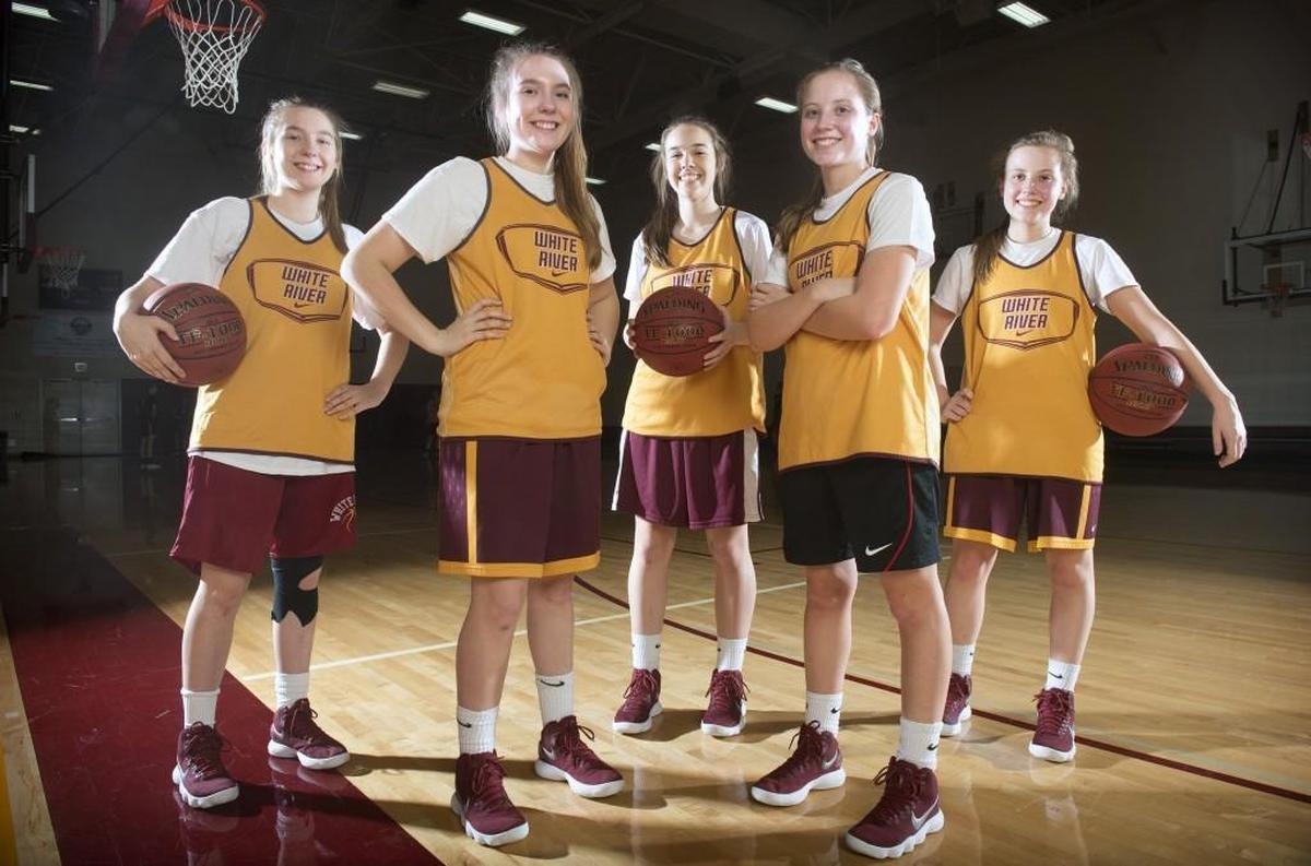 White River girls basketball team has opponents seeing double in senior identical twins Sofia Lavinder and Georgia Lavinder (left) and Megan Cash and Emma Cash (right). Sandwiched in between is another twin, freshman Taylor Schmidtke, who also has a twin sister, Tori Schmidtke. They are shown during a break from basketball practice at White River High School outside Buckley on Wednesday, Jan. 10, 2018.