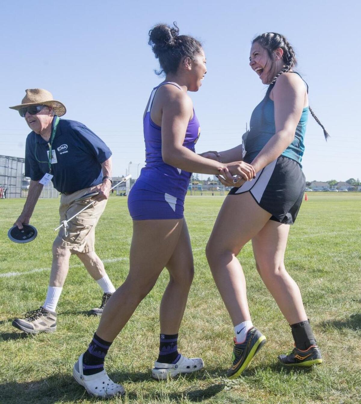 Sumner’s Rhaven Dean (left) celebrates with Bonney Lake’s Dreakeanna Adair after the duo won state championships in the 4A girls javelin and 4A girls discus respectively during the opening day of the 2A-3A-4A Washington State Track & Field Meet at Mount Tahoma High School in Lakewood on Thursday, May 23, 2017.