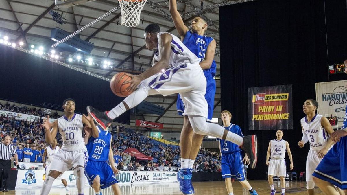 Garfield's Jaylen Nowell soars past Seattle Prep’s J’raan Brooks looking to pass to teammate Alphonso Anderson (10) in the Bulldogs' 64-60 win over Seattle Prep in a Class 3A boys state semifinal at the Tacoma Dome on Mar. 6, 2015.