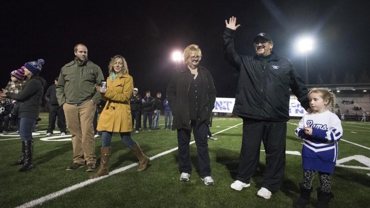 Longtime North Thurston coach Rocky Patchin, waving, is joined by family members as he is honored before his final football game Thursday at South Sound Stadium. Gallery and video at theolympian.com.