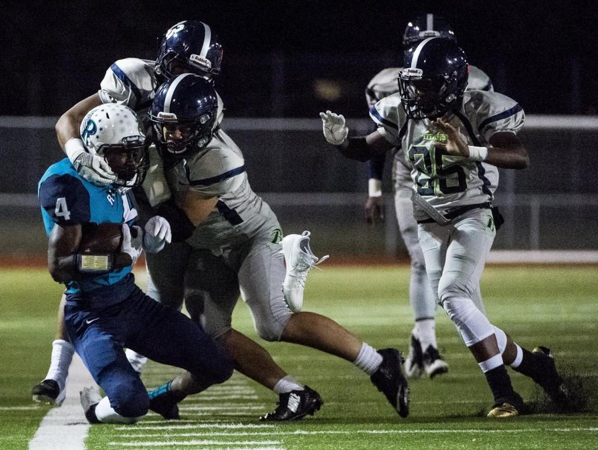 Auburn Riverside's Jaden Robinson (4) loses his cleat as he's tacked in the second quarter. Auburn Riverside played Todd Beamer in a football game at Auburn Memorial Stadium in Auburn, Wash., on Friday, Sept. 29, 2017.