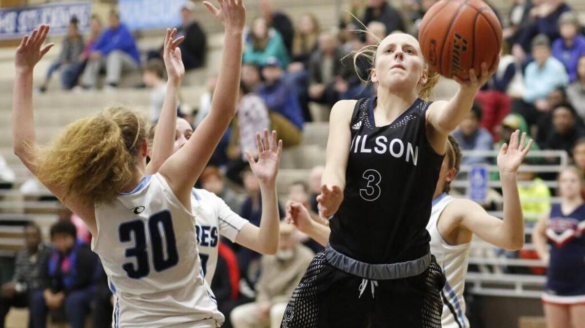 Wilson's Josie Matz (3) puts up a shot through the defense of multiple Gig Harbor players in the third quarter. Gig Harbor played Wilson in a basketball game at Olympia High School in Olympia, Wash., on Saturday, February 11, 2017.