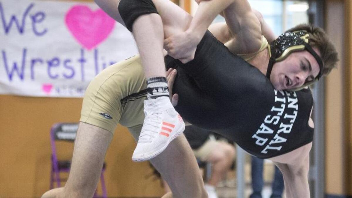 Timberline’s Parker Risk takes down Central Kitsap’s Carsten Wheeler on the way to victory in the 132-pound final Saturday. Three other Blazers claimed league titles, and nine will move on to next week’s regionals.