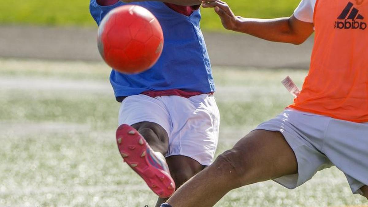 Briskans Shibale, left, and a teammate vie for the ball last month in soccer practice at Mount Rainier High School in Des Moines.