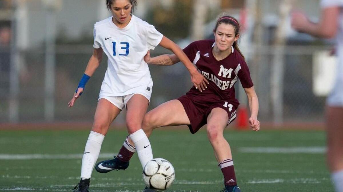 Ellie Hensey (14) of Mercer Island and Monique Nagel (13) of Stadium struggle for the ball during the second half at Sparks Stadium in Puyallup, on Saturday, Nov. 18, 2017. Mercer Island won 4-1.