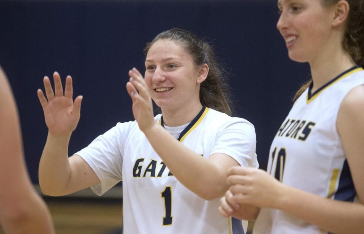 Annie Wright freshman Julianna Walker greets teammates during player introductions before Wednesday night’s girls basketball game against Bush at Annie Wright Schools in Tacoma on Feb. 7, 2018.